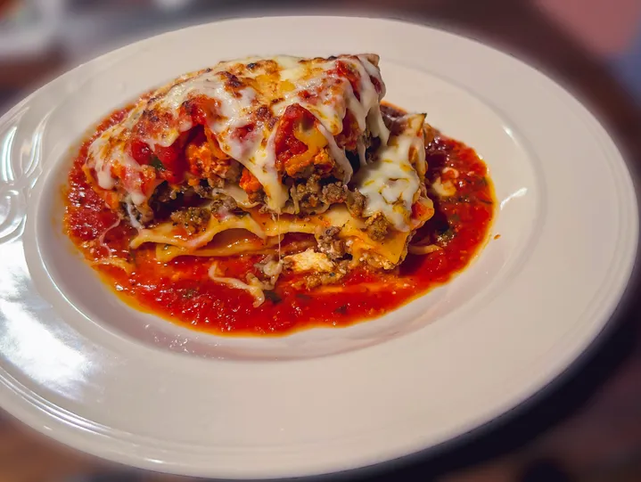 Lasagna in tomato sauce served as a family-style banquet main course