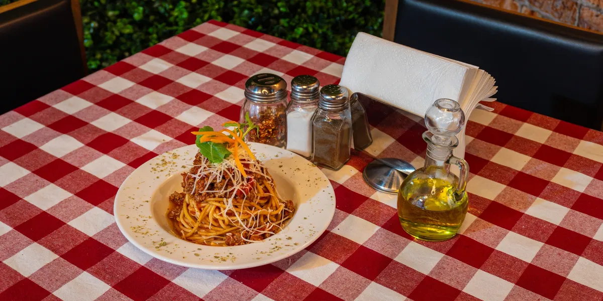 Spaghetti on a red checkered tablecloth at The Italian Oven McLean